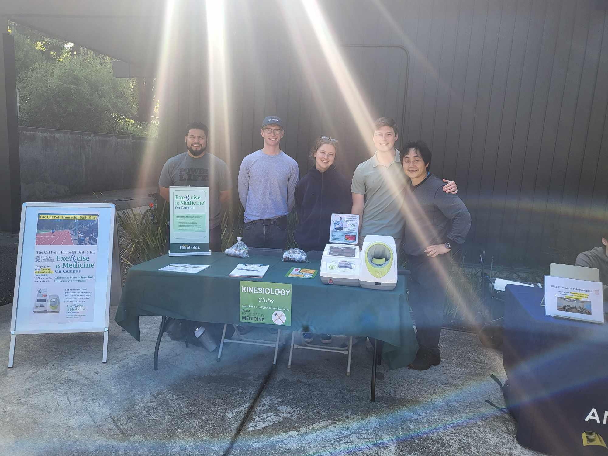 Group of students and club advisor at Kinesiology Club table